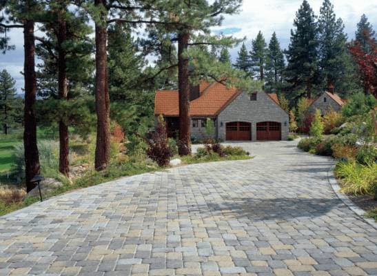 picture of a newly installed paver driveway with gray textured pavers