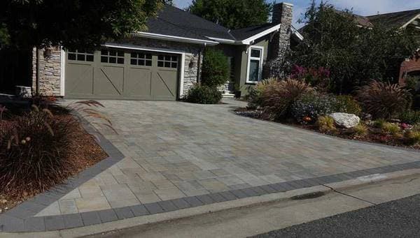 picture of a newly installed paver driveway with gray textured pavers